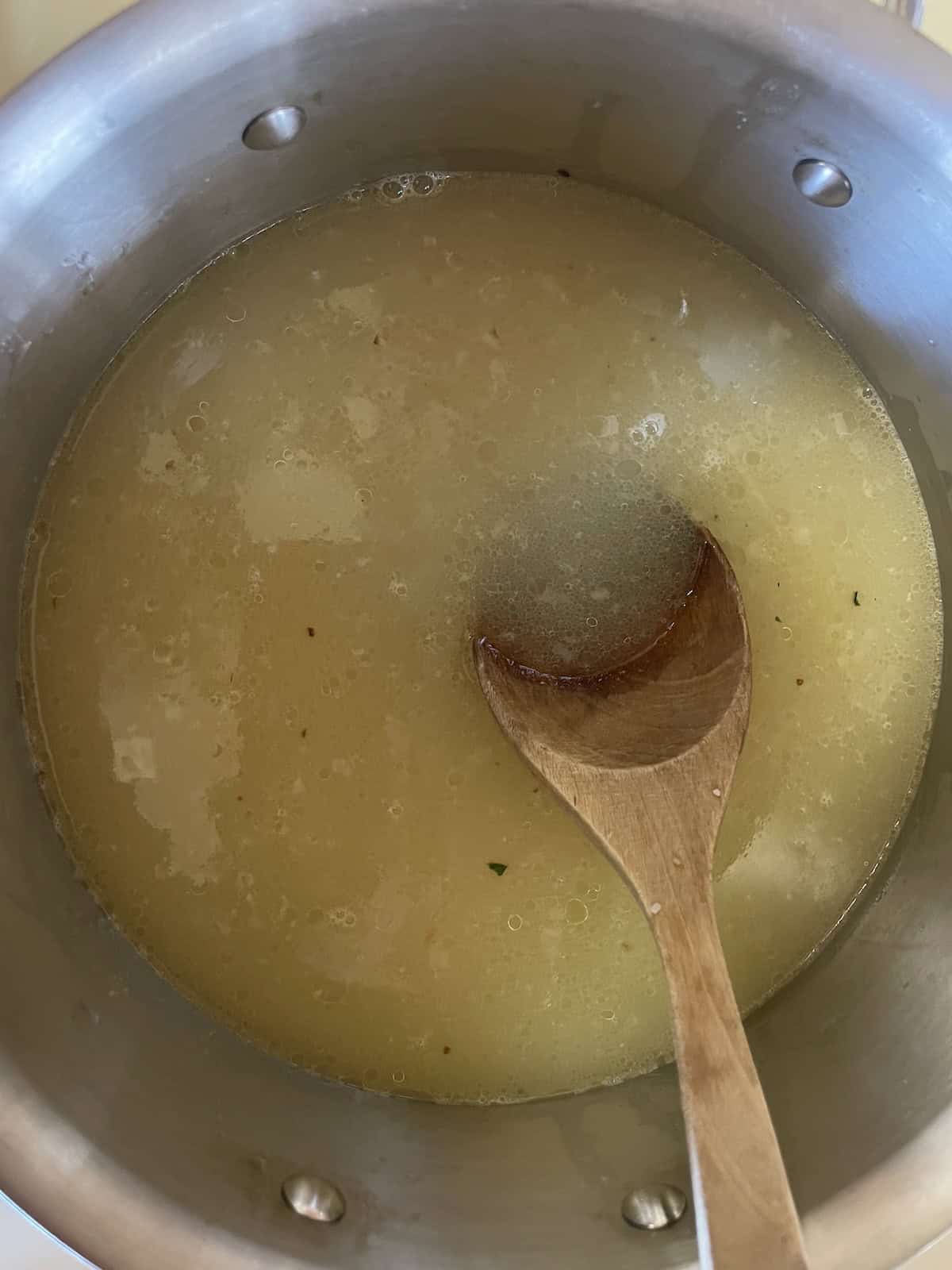 add chicken broth to pan