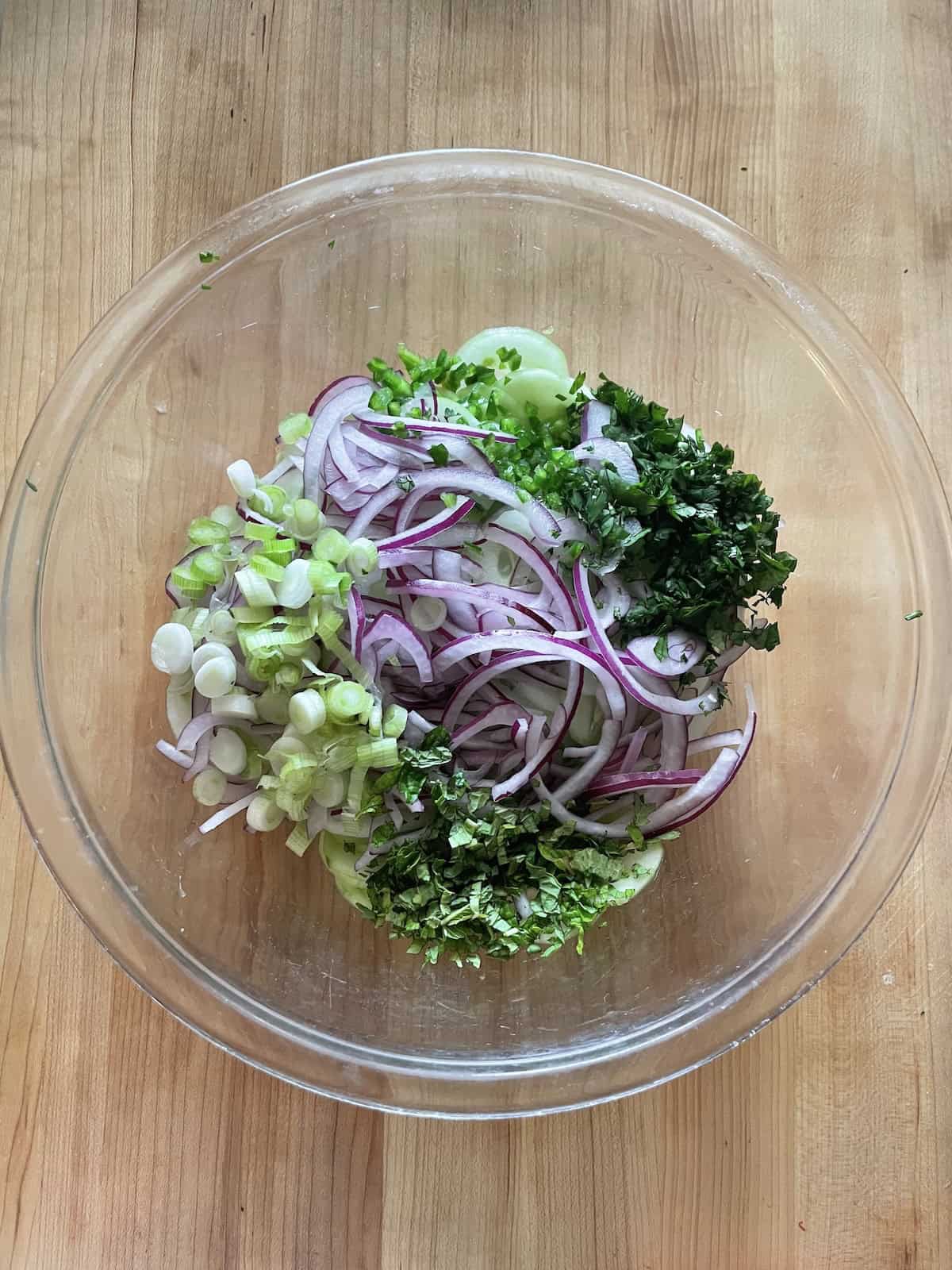add ingredients to th bowl with the dressing