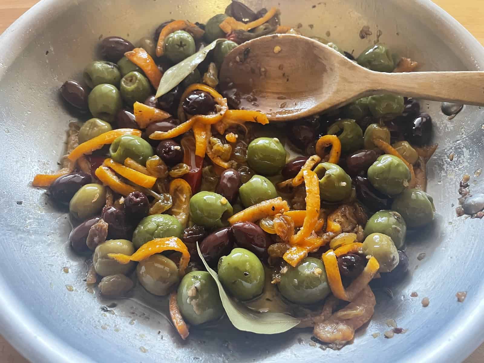 Orange and Chili Marinated Olives and Currants in a skillet