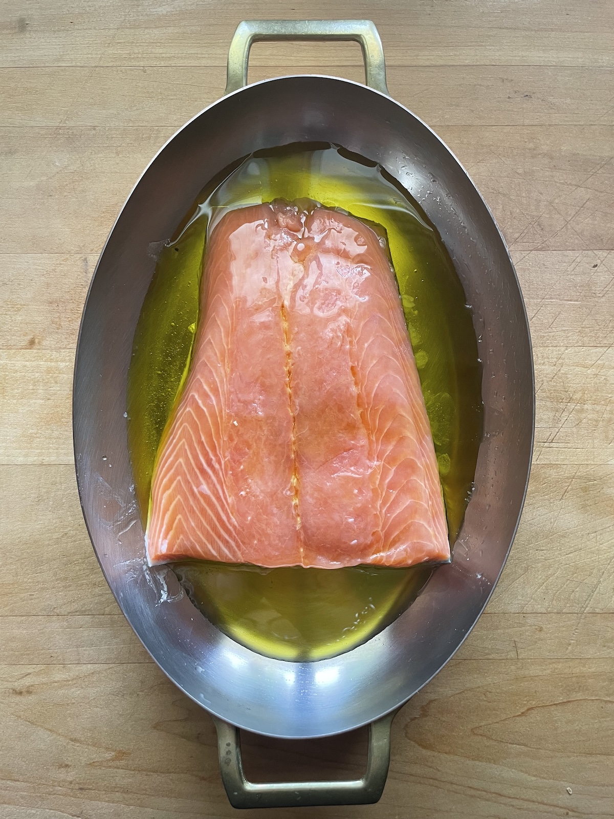 salmon in baking dish with olive oil