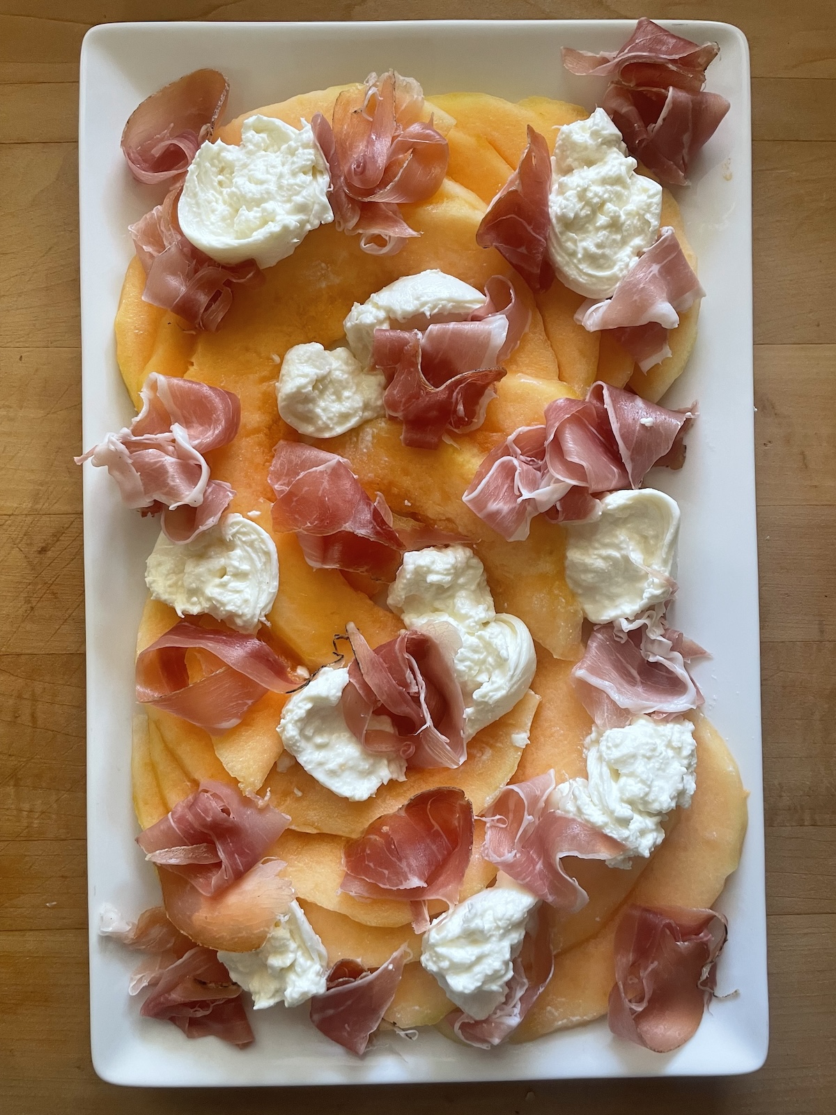 arrange prosciutto over the melon